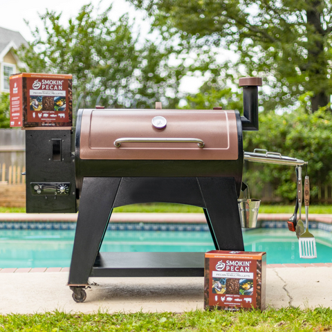 Barbecue grill with Smokin' Pecan wood chips by a poolside