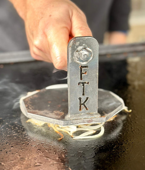 burger press with FTK engraved on it