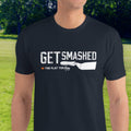 Person wearing a black t-shirt with 'GET SMASHED' text and graphic outdoors.